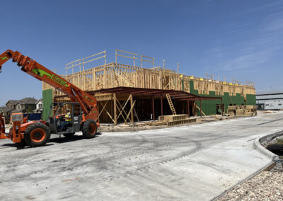 Avid multi-story building under construction in Austin, with exposed wood framing and a crane on site.